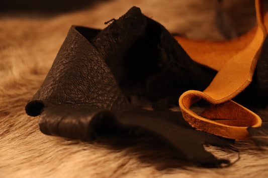 several scraps of leather in assorted shapes and colorways, perfect for DIY leather crafting.