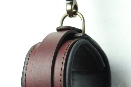 A closeup of the stitching and deerskin lining on this brown leather bdsm cuff. 