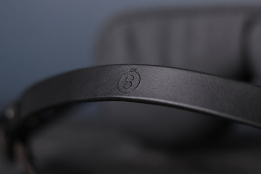 A closeup of the blindfold head harness strap in black leather.