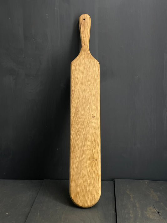 Back of the Oak spanking paddle, made of wood. 
