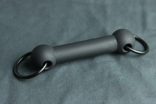 A silicone bit gag with rings on each side for clipping into a leather head harness or ballgag harness. 